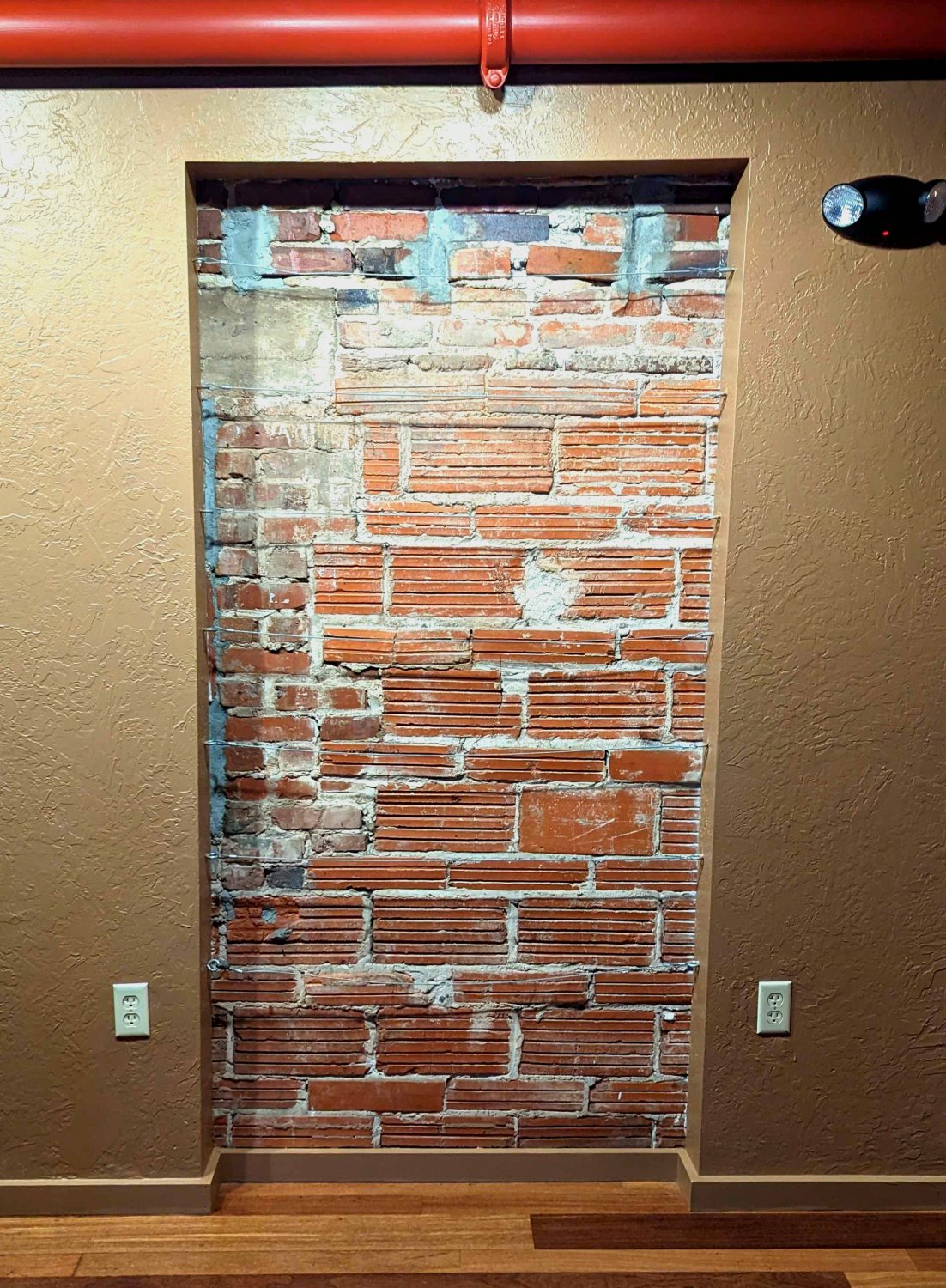 Upstairs on the SOUTH side of NOVA 535 is a beautiful brick wall with 7 wires that clients and guests use to hang seating chart cards, photos and artwork